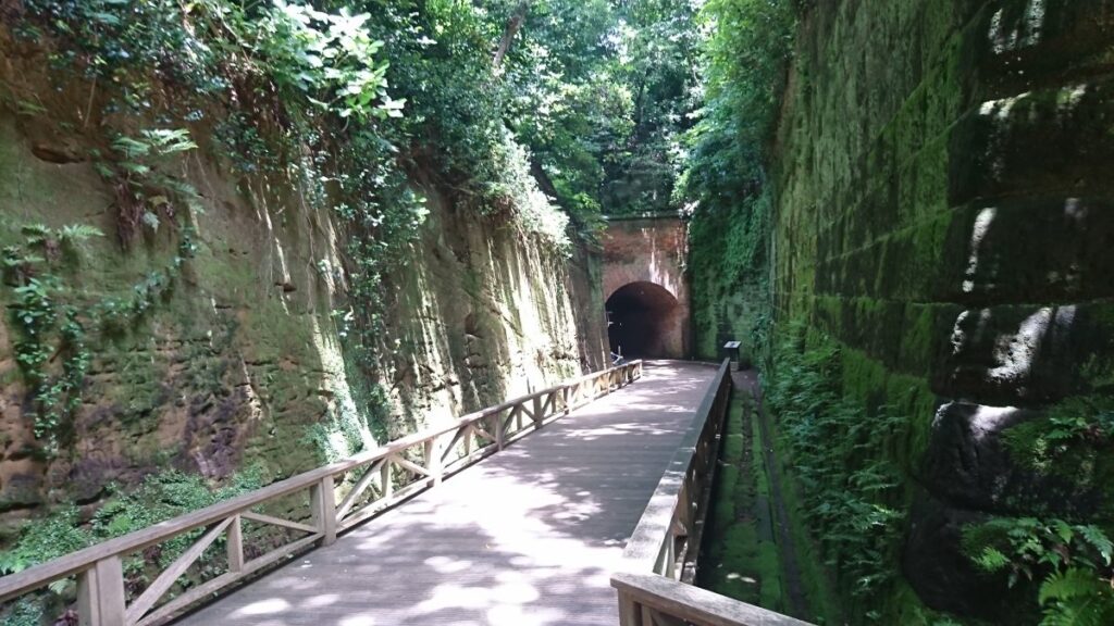 A road leading to a brick tunnel