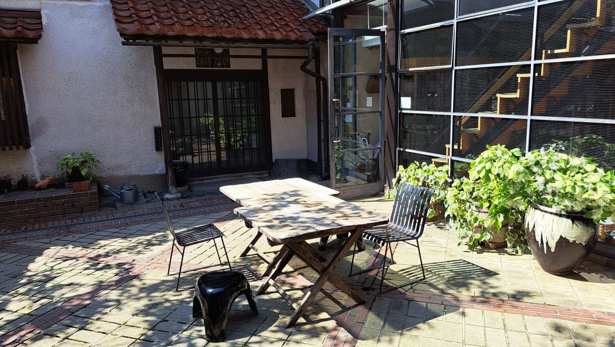 A table and chairs amidst the dappled sunlight at "Kogensha"