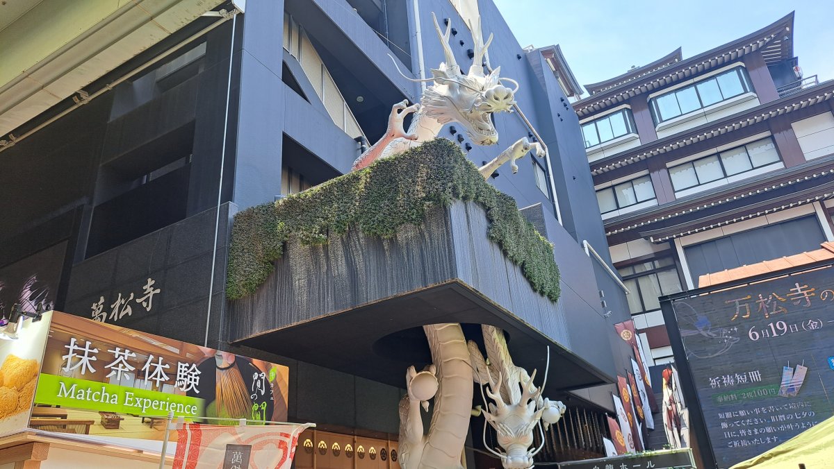 A white dragon bursting through a building in Osu.