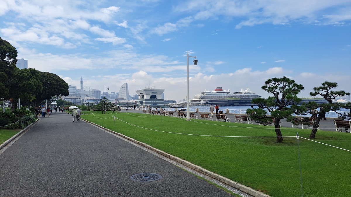 Sea, lawns, and lush greenery.